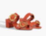 Orange heeled sandals with gold buckle accents perfect for walking in Las Vegas.