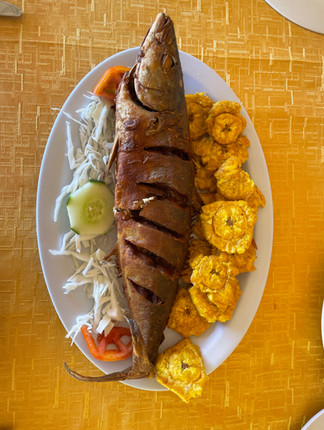 Dominican traditional dish: Pescado Frito and tostones. What to eat in DR. 