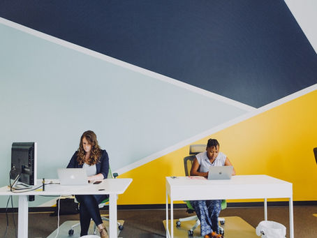 Painted walls with pattern in office with white desks