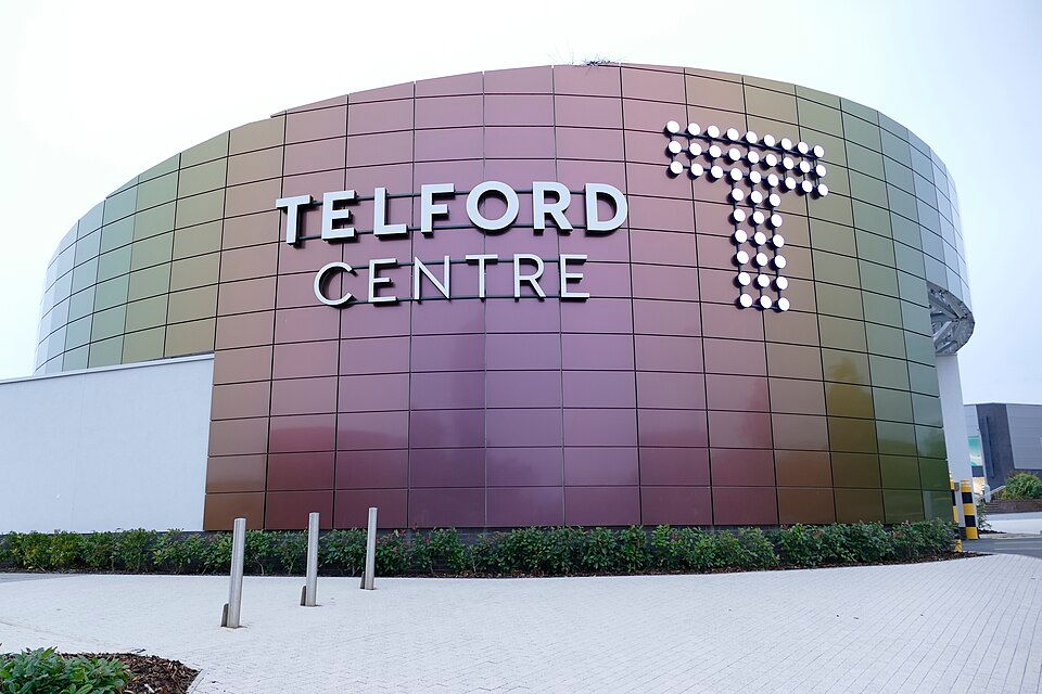 Entryway to the Telford International Centre, a modern complex featuring a large glass and steel atrium entrance.