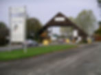 Entrance to the NAEC Stoneleigh (National Agricultural and Exhibition Centre), showing low, modular modern exhibition halls in a parkland setting.