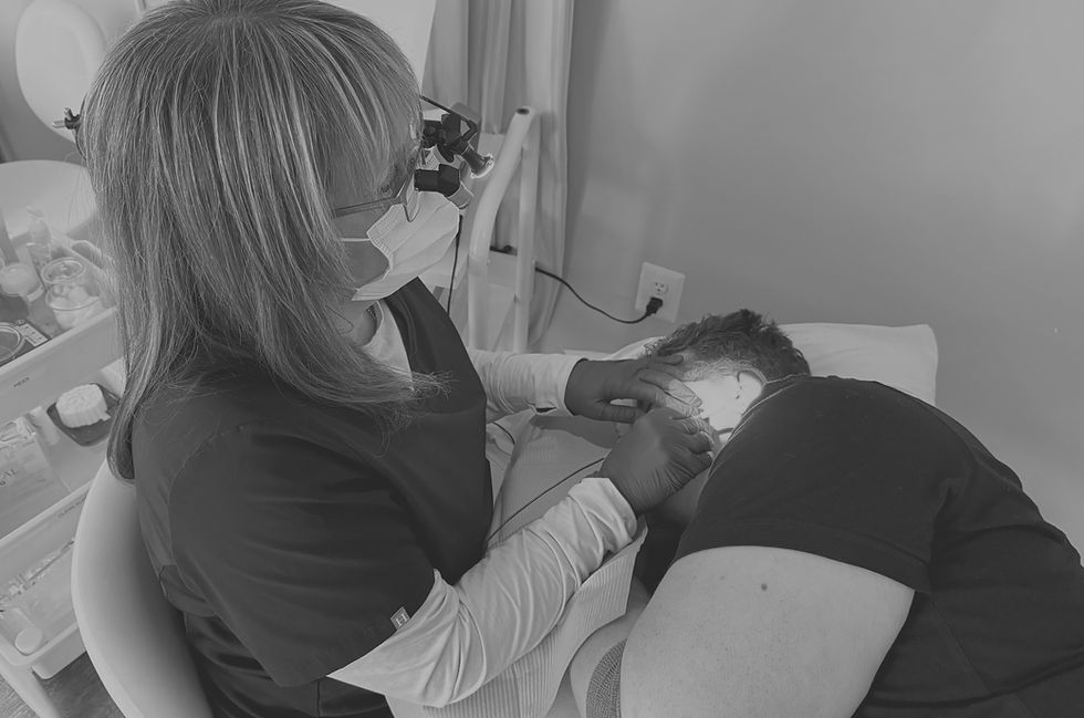 Electrology treatment in progress, showing a practitioner performing a precise hair removal procedure in a calm clinical sett