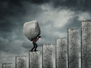 Man carrying heavy boulder up steps