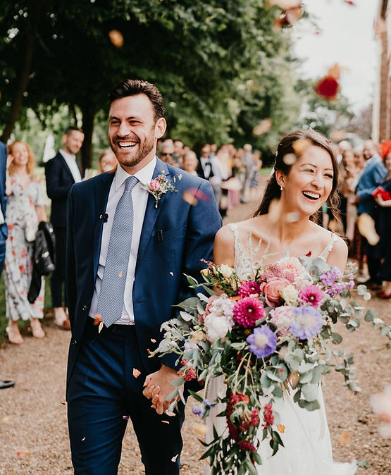 Bride and groom with cascading flower bouquet