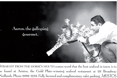 A black and white press advertisement features a smiling man, Aaron, gently holding a stylised horse sculpture. The text reads, 'Aaron, the galloping gourmet'. It promotes Aristos restaurant, known for seafood, showcasing artwork by John Sander.