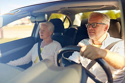 Smiling man and woman in car