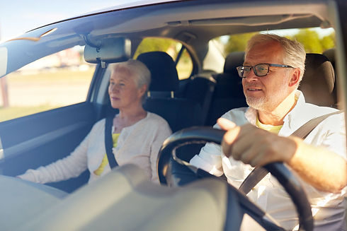 Man and woman smiling in car