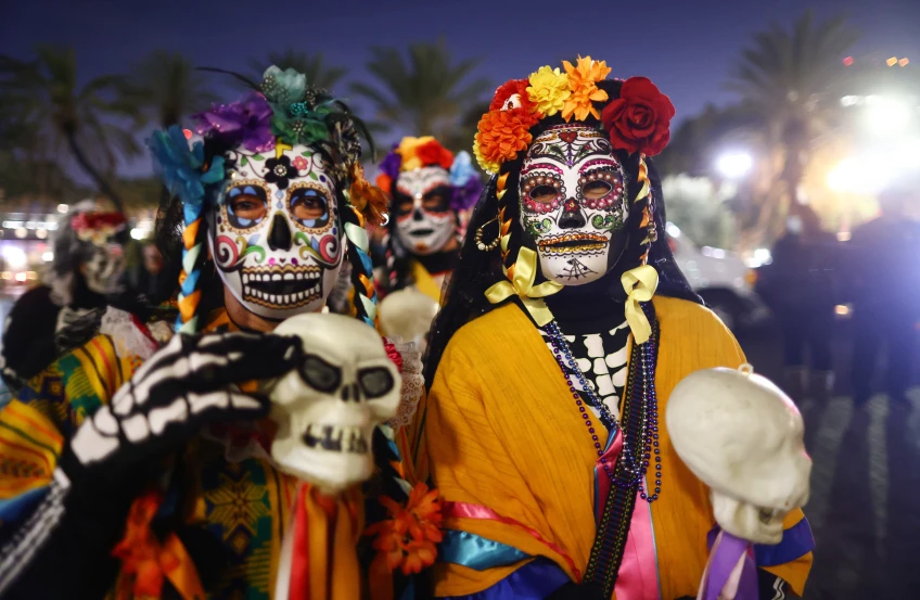 Celebrators of Dios De Los Muertos in painted bone masks