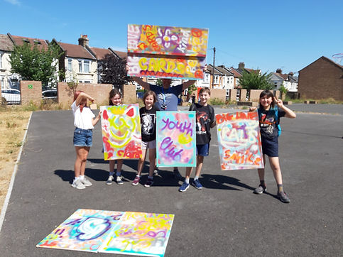 Children showcasing posters from our Youth Club