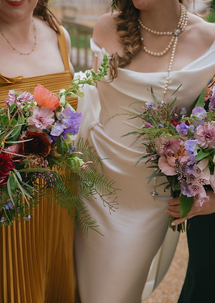 film photograph of a bride and her bridesmaids carrying bouquets