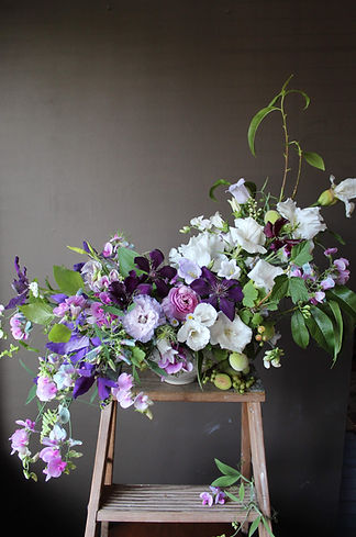 an organic purple lilac and creamy white floral design by Darling and Daughters