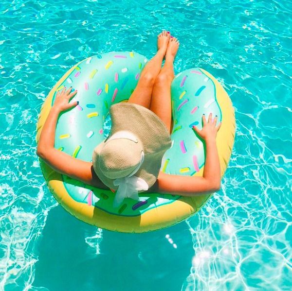 Lady floating on a doughnut pool toy