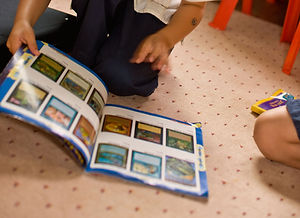Child Browsing Trading Cards