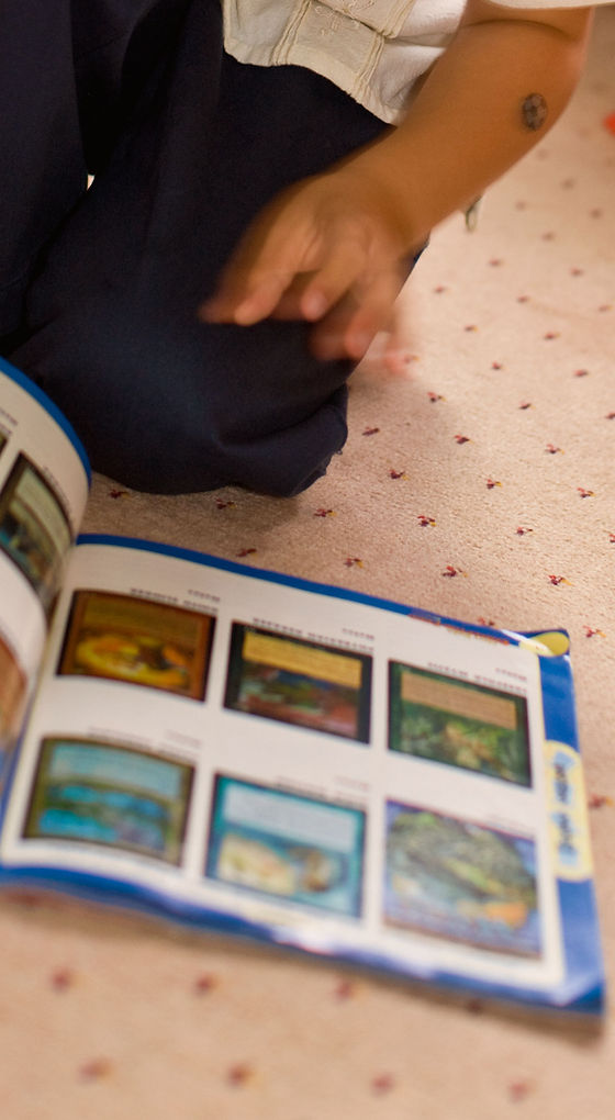 Child Browsing Trading Cards
