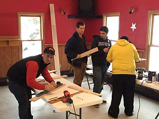 Brothers having a workshop to make membership paddles for alumni