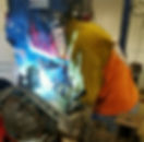 Man welding axle truss