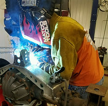 Man welding axle truss