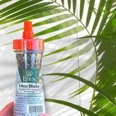 Hand holding Eden Shake Sesame & Sea Vegetable Seasoning bottle
