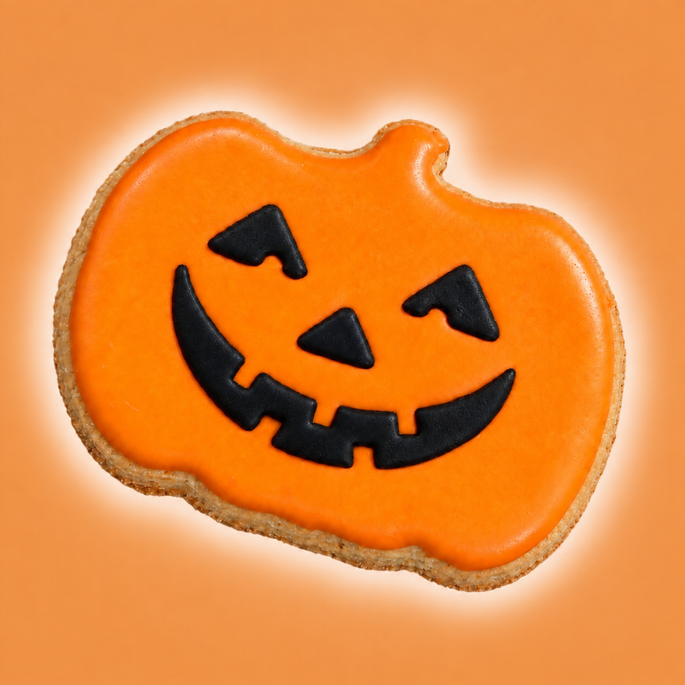 Jack-o’-lantern Halloween dog cookie with orange icing and black carved face on warm orange background