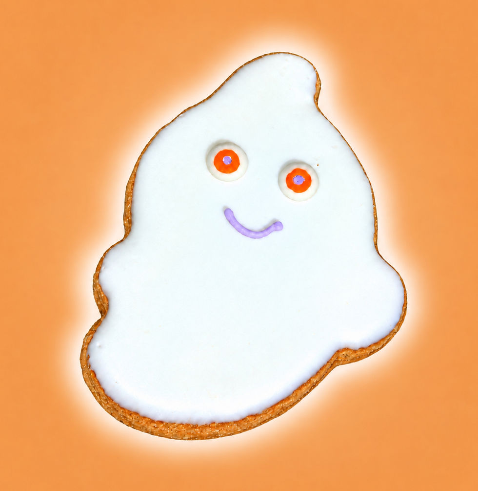 Frankenstein Halloween dog cookie with neon green icing, black hair and bolt details on orange background
