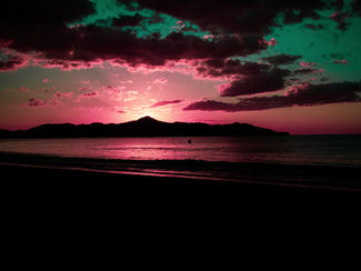 Tropical island sunset over calm sea.