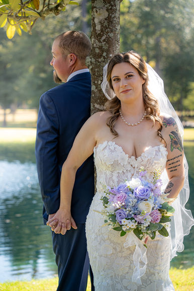 Bride and groom sharing their first look under a magnolia tree at a wedding in Conroe, Texas