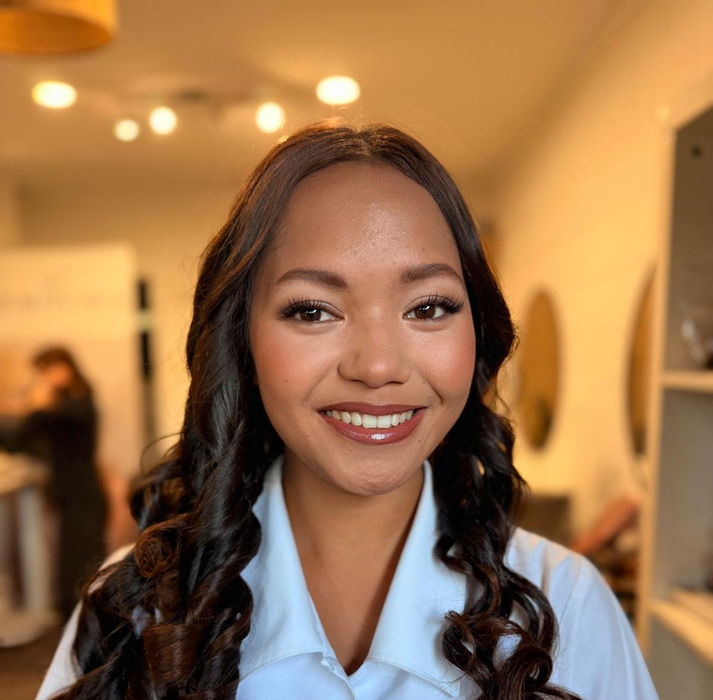 A girl smiling with Natural Makeup and Curls