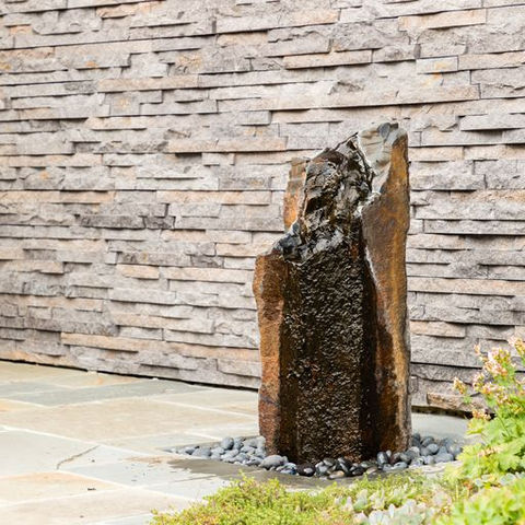 Close view of rock water feature near bluestone steps in Walnut Creek
