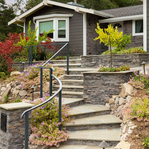 Stone and planting details framing a hillside entry garden