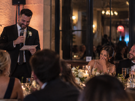Wedding speech with the bride and groom laughing at the reception.