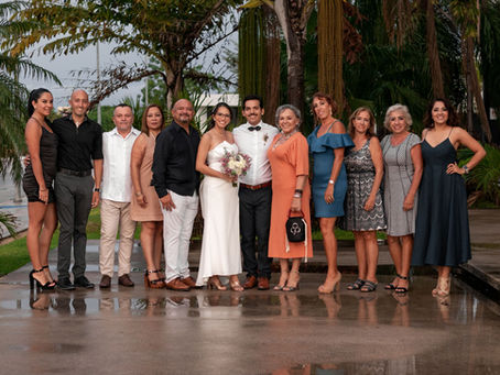 Wedding family photos with a bride and groom posing with a large group of relatives.