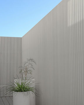 Private Outdoor courtyard with custom timber screening, blue sky