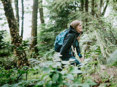 A content woman hiking in a forest