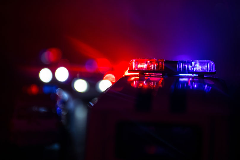 Police cars at night. Police car chasing a car at night with fog background. 911 Emergency