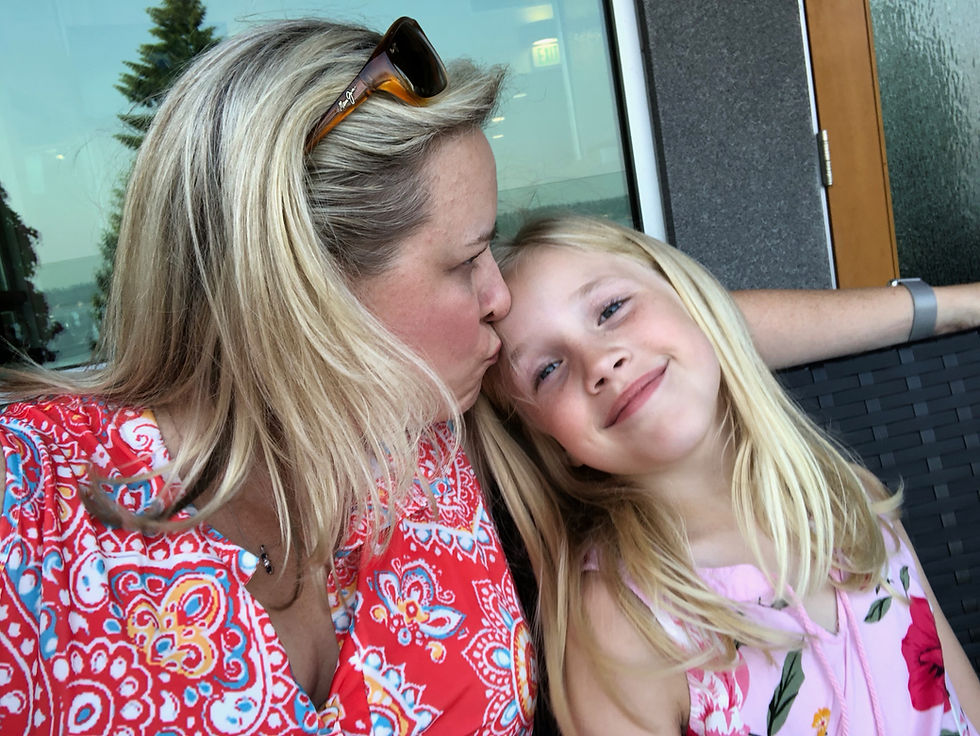 Mom kisses girl parenting