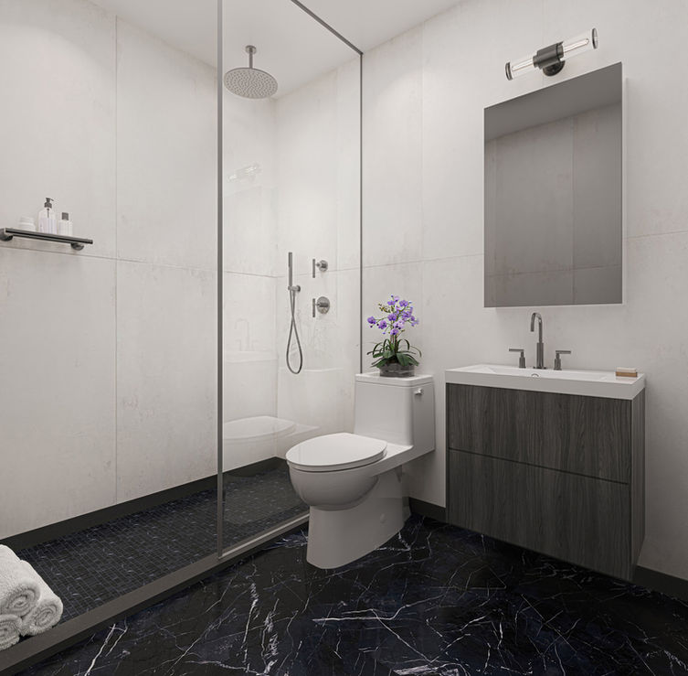 Primary bathroom with glass enclosed walk-in shower.