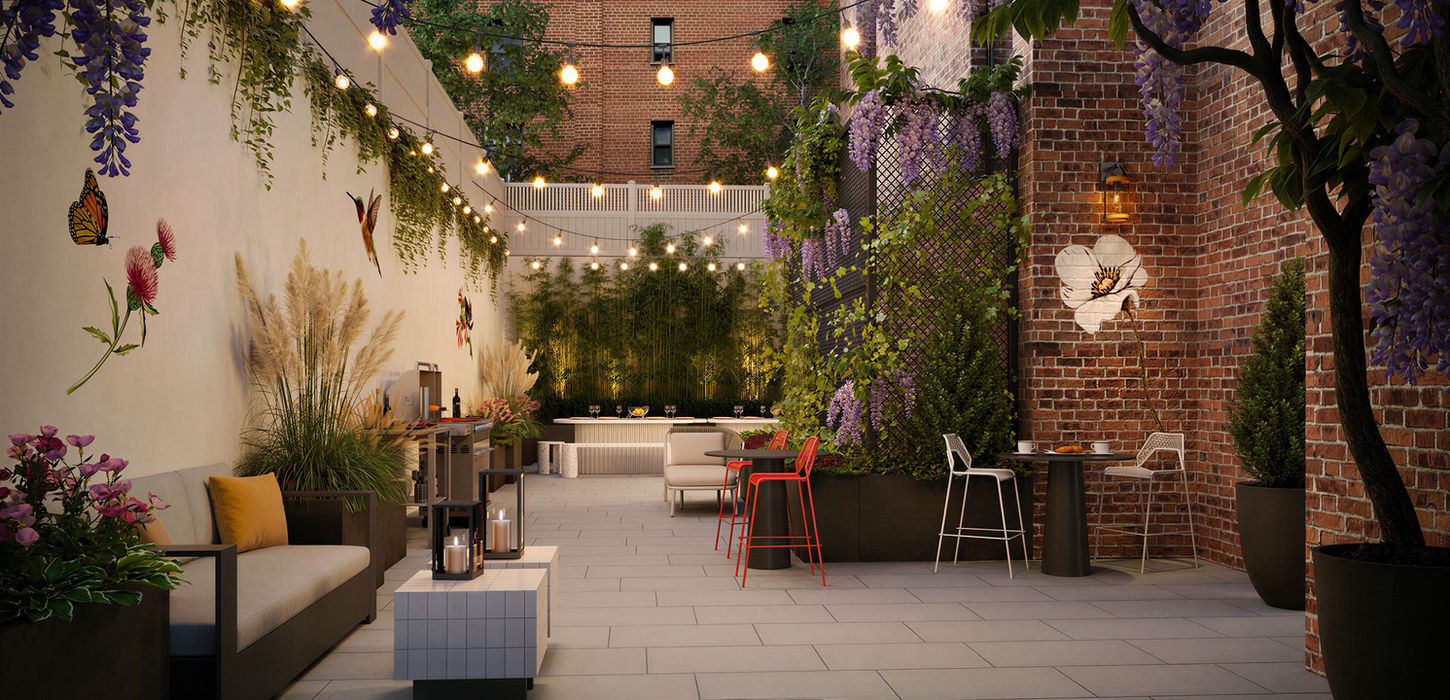 Lushly landscaped courtyard at night with market lights overhead.