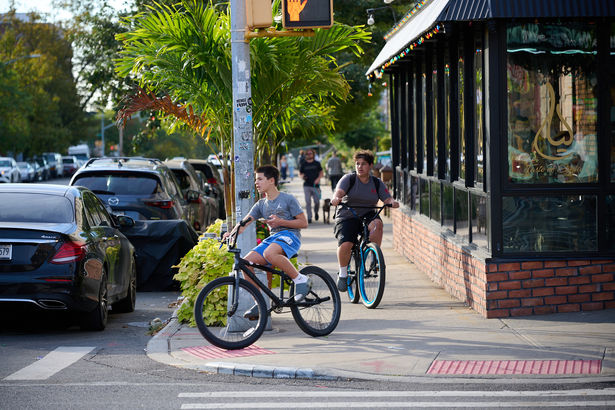 Kids on bikes on sidewalk in Bay Ridge.