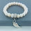 Thumbnail: Cultured white pearl with sterling silver angel wing charm bracelet