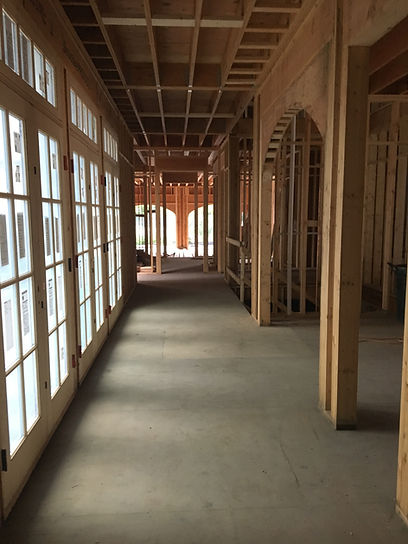 Interior framing detail of a high-end custom home showing structural layout, sequencing, and early construction work.