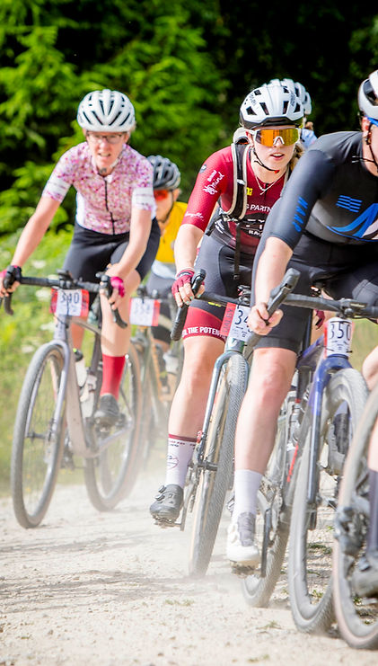 Group of female riders racing on gravel bikes