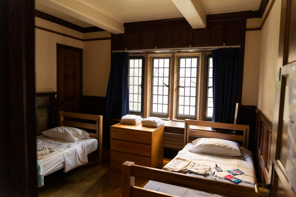 Yale dormitory room with beds and large windows.