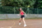 ISSOS Tennis elective student driving a forehand on an outdoor court.