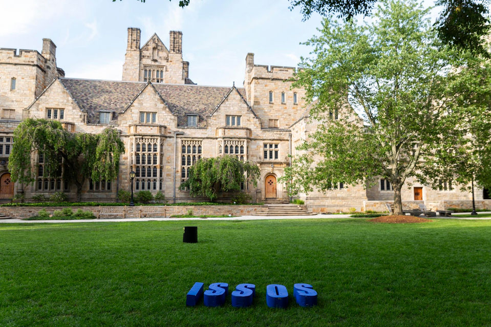 Yale University building with ISSOS letters displayed on the lawn.