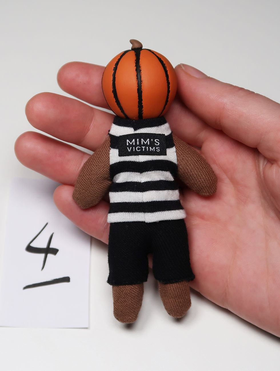 Thumbnail: 4" orange mini pumpkin doll in striped shirt