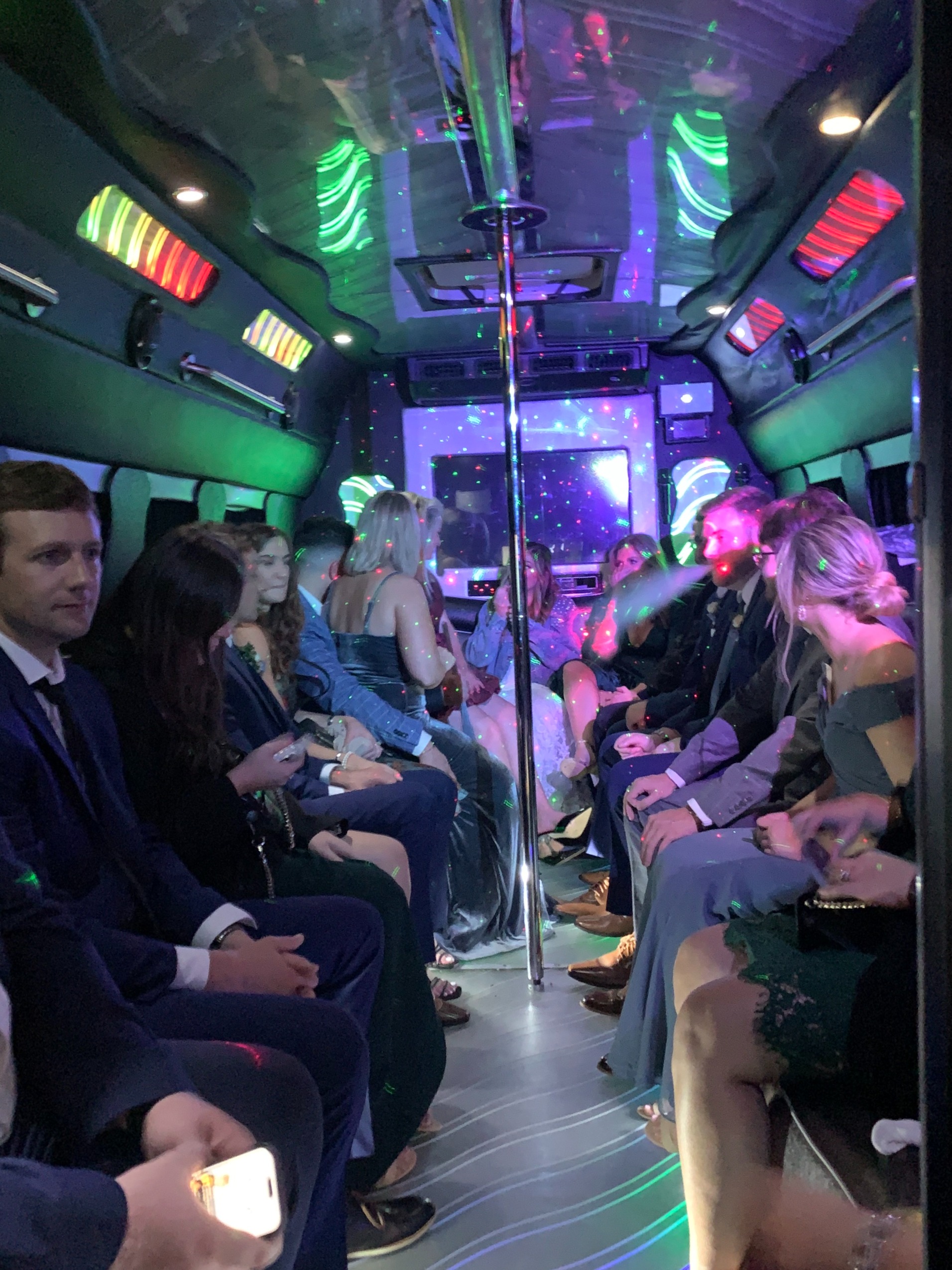 People in Formal Attire Inside CharlotteLUX Party Bus