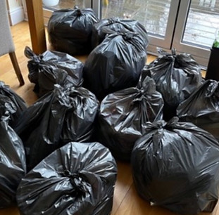 Collection of Bin Bags waiting to go to the charity shop to be donated. Decluttering Crew aways recycle responsibly.