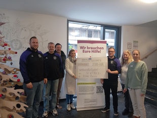 Gruppenfoto mit Spendenscheck über 2.500 Euro für das Kinderpalliativteam „Kleine Riesen“.