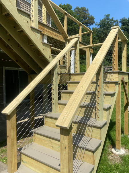 Newly constructed deck with cable railing by Ryan Davis Contracting. deck construction services