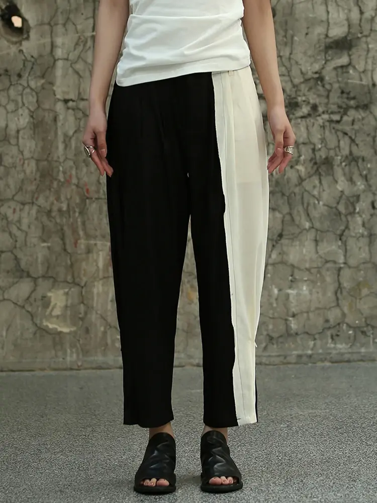 Cusuti Black jersey knit harem pants with a relaxed fit, drawstring waist, slight stretch, hollow-out details, and pockets.